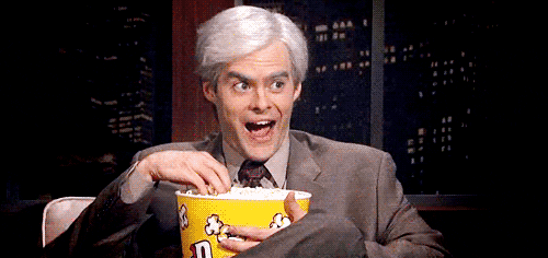 Animated gif of Bill Hader eating popcorn enthusiastically