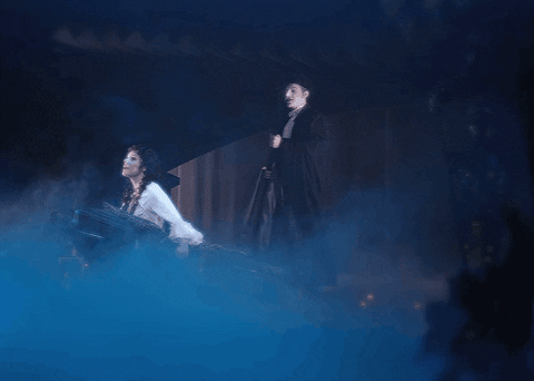 Animated gif of the Phantom of the Opera rowing Christine in a boat through the mist.