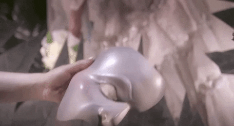 Image of a hand holding the Phantom's mask