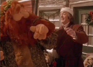  An animated gif of Scrooge dancing with the Ghost of Christmas Present, from  A Muppet Christmas Carol.  