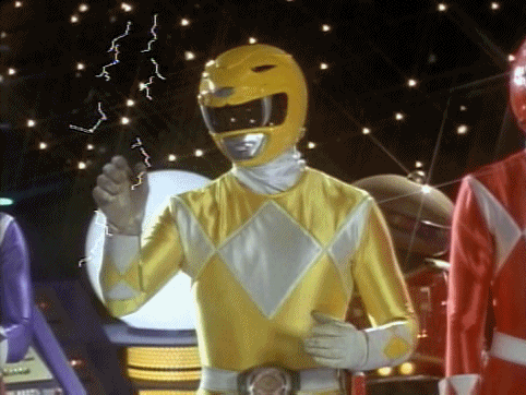  An animated gif of the Yellow Power Ranger holding up knives, which sparkle with lightning. 