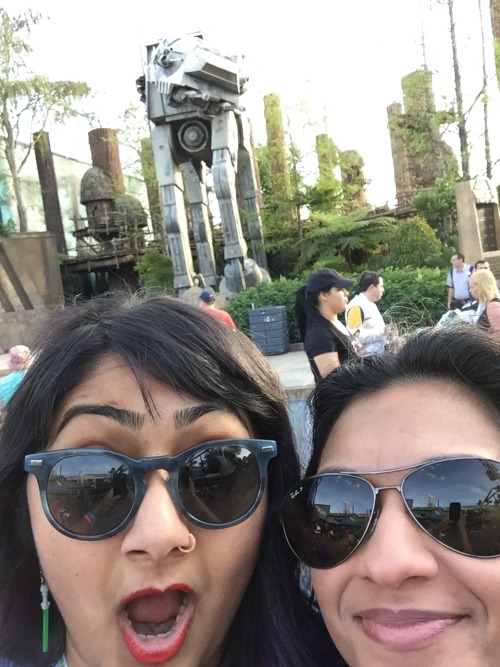  Preeti (L) and Swapna (R) take a selfie in front of a life-size AT-AT. 