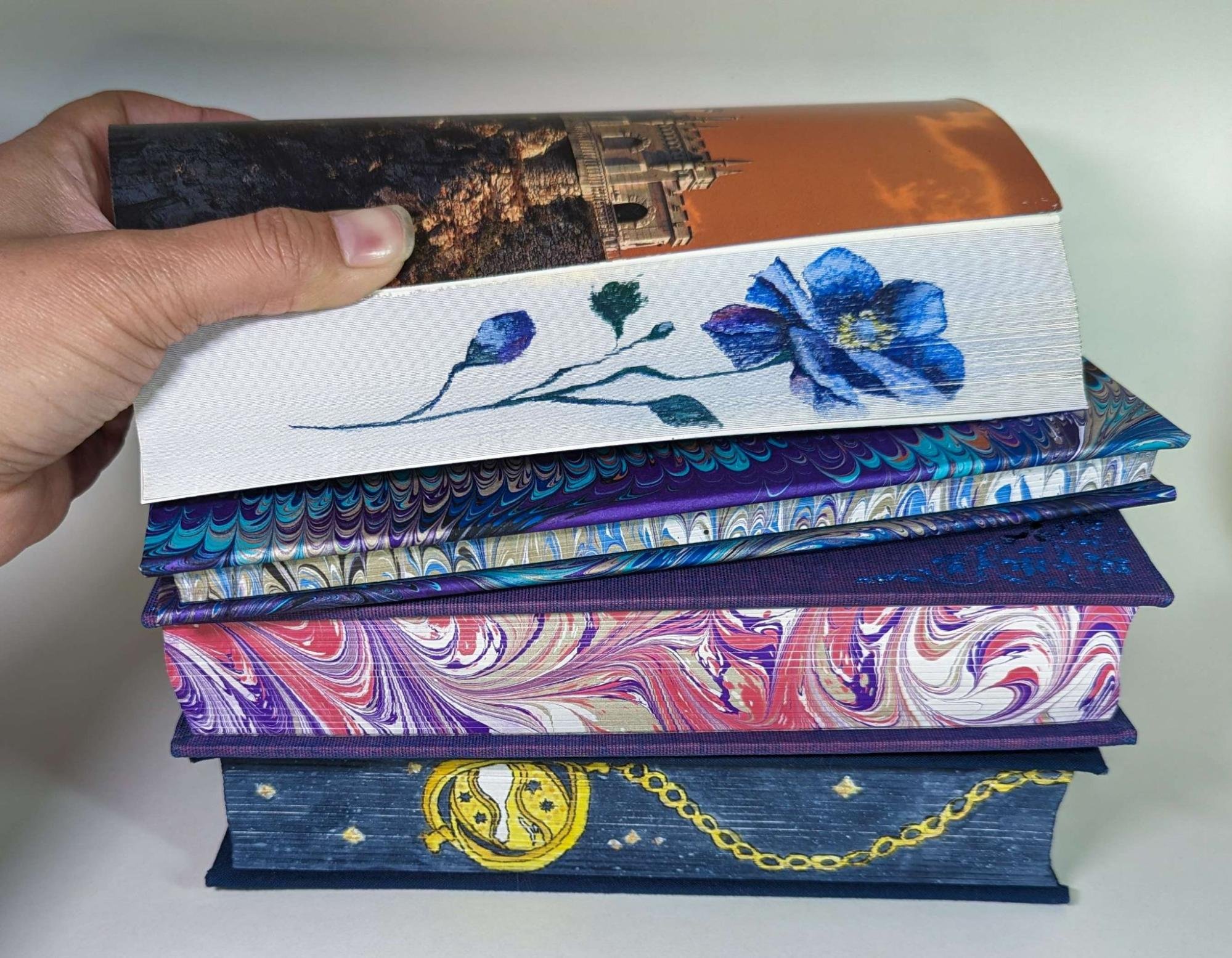 Image of a stack of books with elaborately painted edges