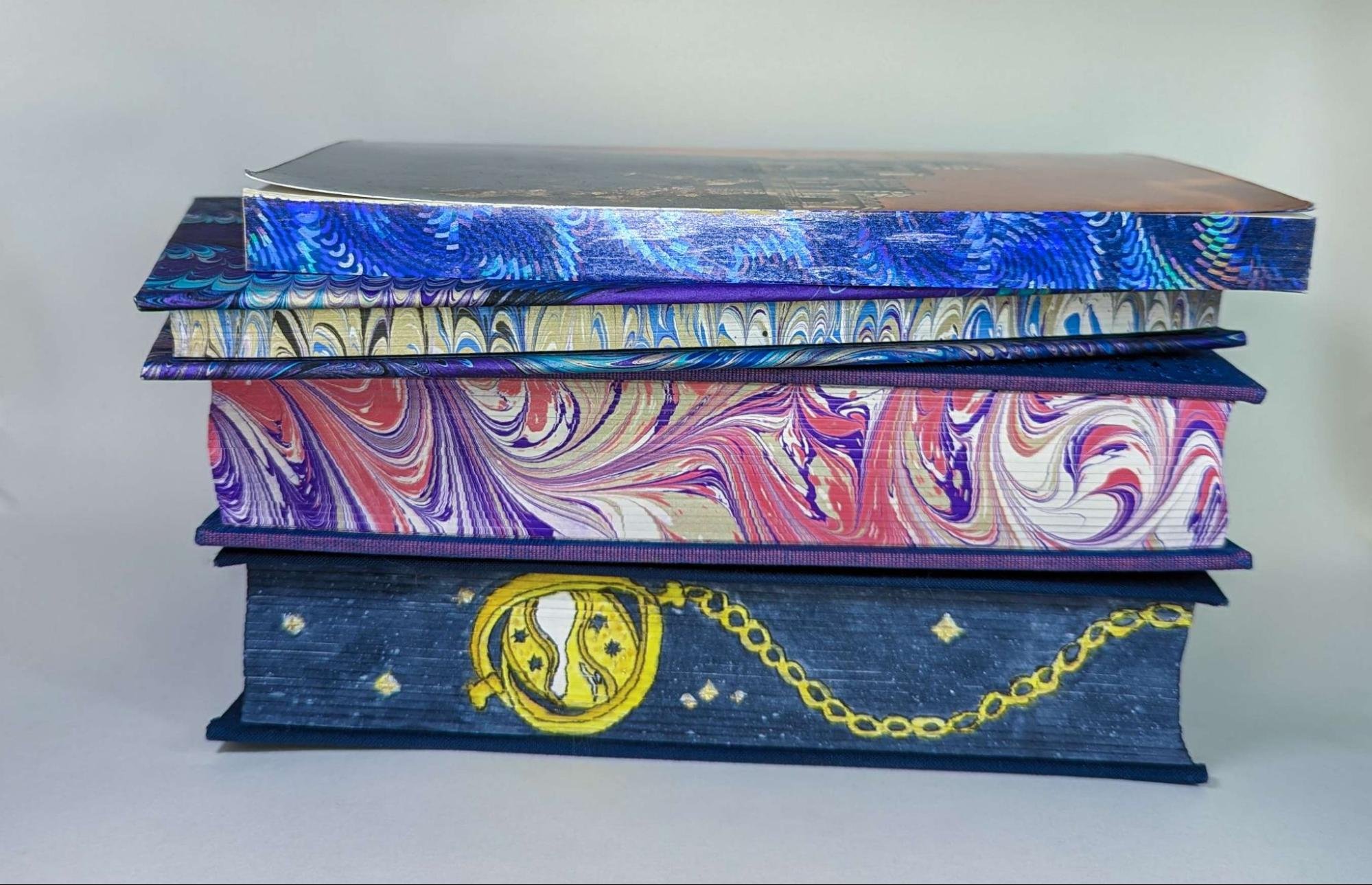 Image of a stack of books with elaborately painted edges