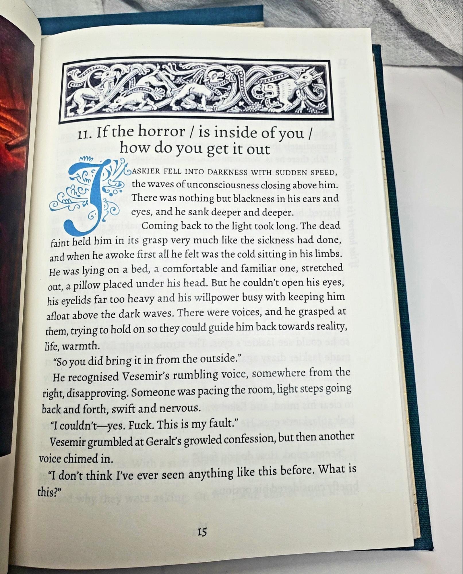 Image of an opening page a fanbinding with a Medieval-woodcut-style illustration of wolves at the top and an illuminated manuscript style drop-cap at the start of the text.