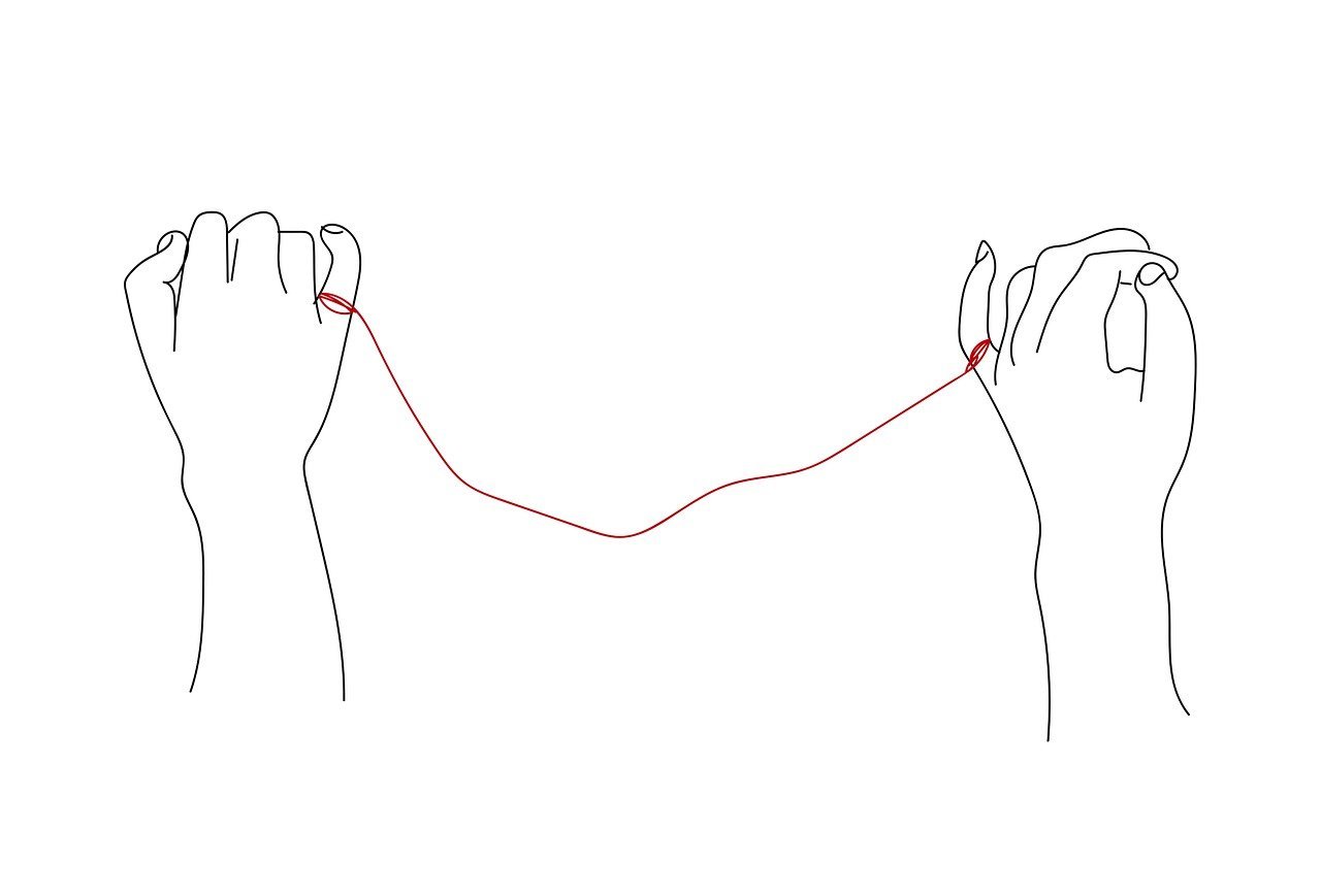 Line drawing of two hands connected by a red string