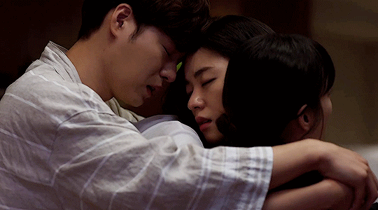  Three people hug in “Melo is My Nature.” 