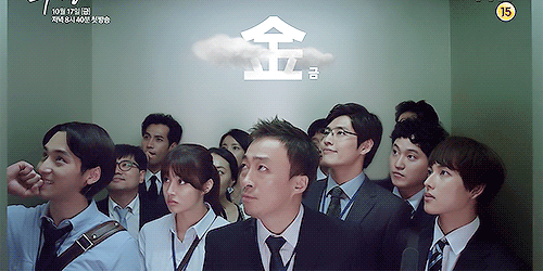  A gif from “Misaeng” featuring a group of a dozen people turning towards the camera and screaming. 