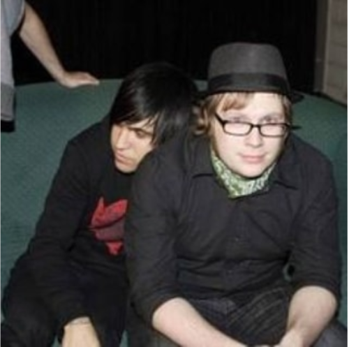 Photograph of Patrick and Pete resting against each other.