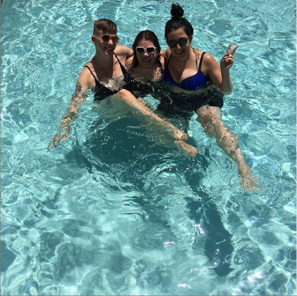  Flourish, Elizabeth, and friend-of-the-pod Nozlee wearing sunglasses and posing in a pool. 