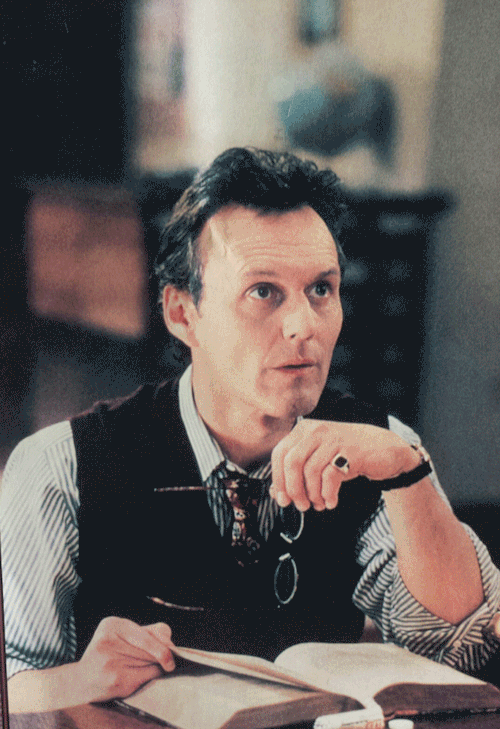  A gif of GIles with books fading in around his face. 