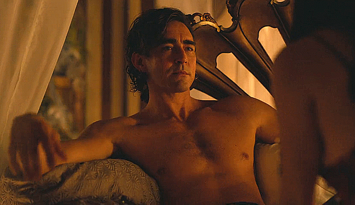 Animated gif of Lee Pace in Foundation, shirtless and lounging on a bed, making a come-hither gesture.