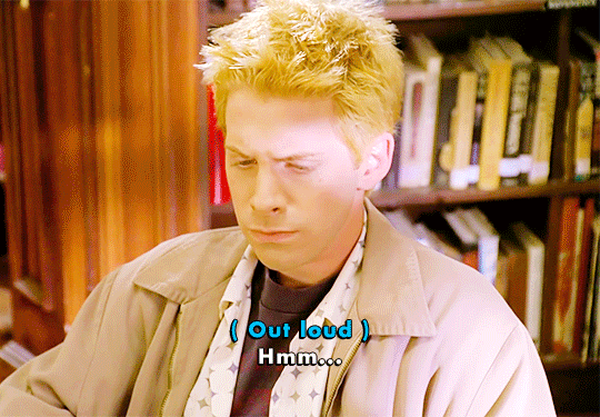 Gif cutting between Oz and Buffy from Buffy the Vampire Slayer, with the caption "(Out loud) Hmm...." over Oz's image