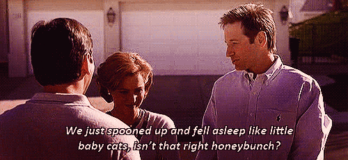 Animated gif from the X-Files episode "Arcadia": Mulder and Scully nudging each other with the caption "We just spooned up and fell asleep like little baby cats, isn't that right honeybunch?"