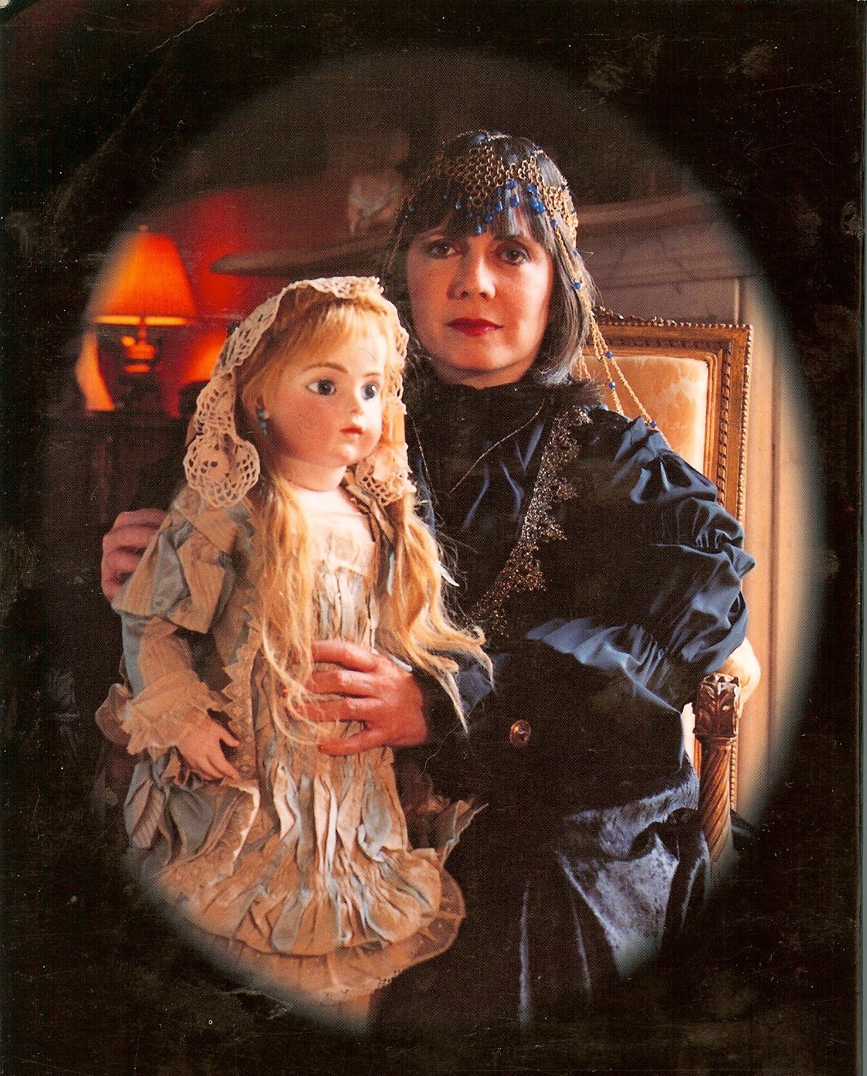Author photo of Anne Rice wearing an elaborate gown and headpiece, holding a blond haunted doll