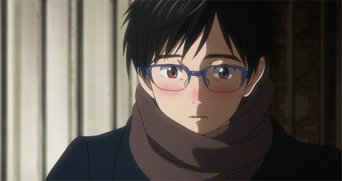 Animated gif of Yuuri Katsuki in a scarf and glasses looking up and blushing.