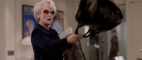 Animated gif from DVP 1 with Miranda chucking her coat and purse on Andy's desk
