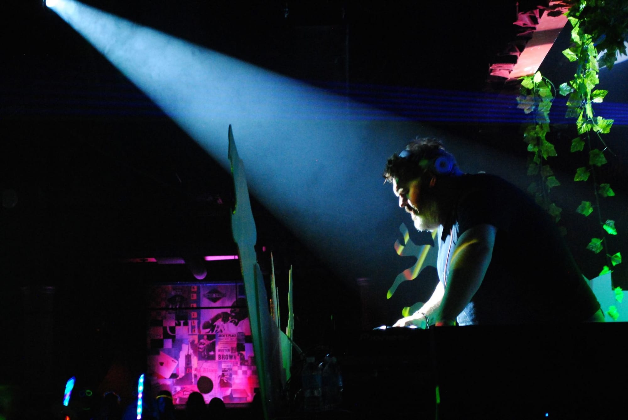 Photograph of the actor who plays Hodor djing at a rave, a shaft of light hitting his face