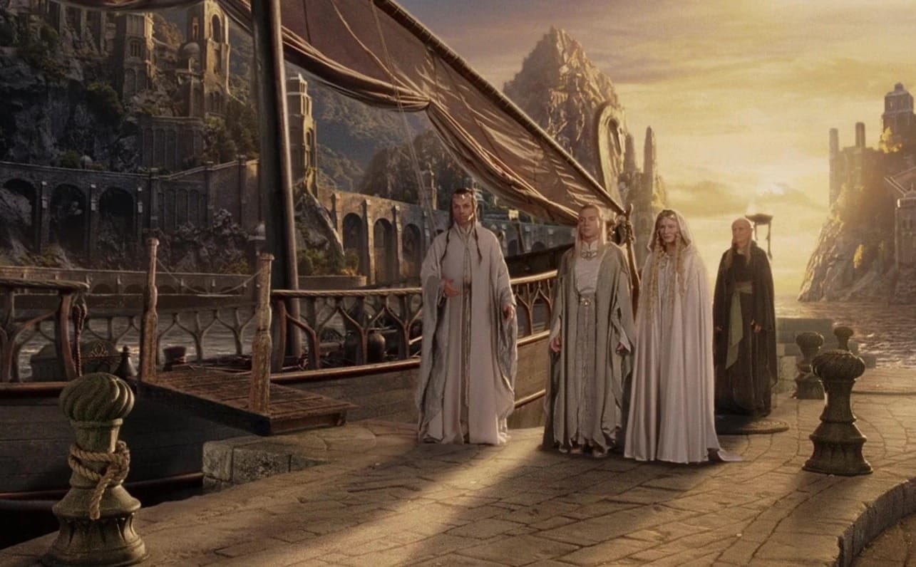 Image of a collection of elves dressed mostly in white and grey standing next to a ship, cast in the golden glow of sunset.