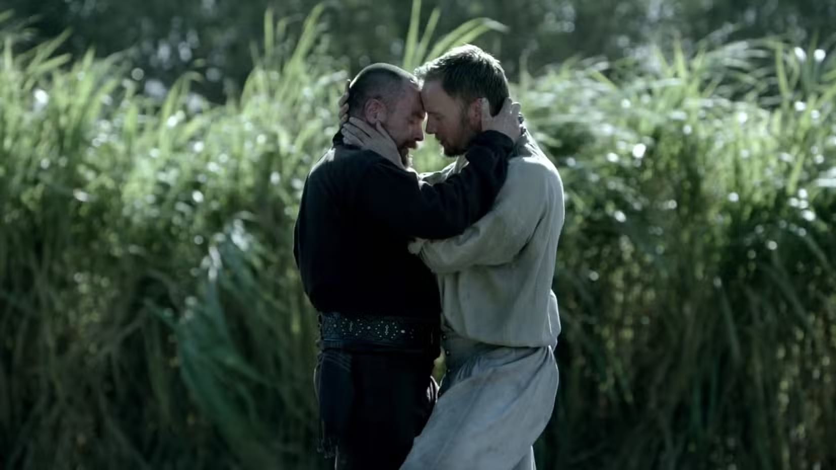 Production still featuring Flint and Hamilton embracing in a field.