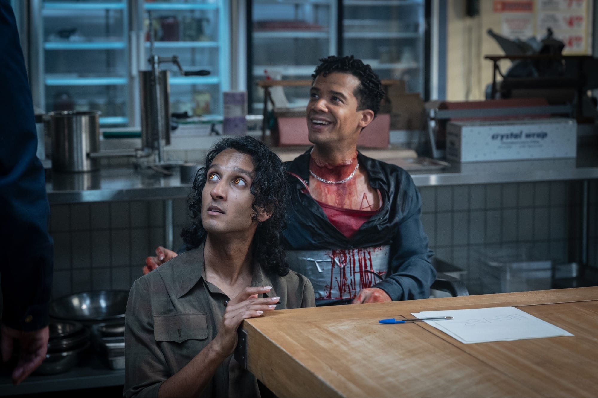 Behind the scenes image featuring Assad Zaman and Jacob Anderson while shooting the butcher-shop scene.