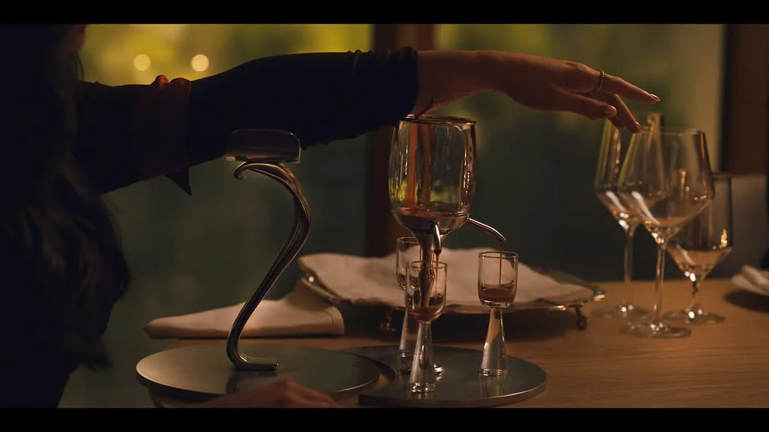 Image from TVL featuring Lestat's descendant with her arm stretched over a goblet, blood pouring downwards.