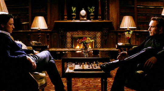 Animated gif of Charles and Erik sitting across from each other at the chess board, aka foreplay.