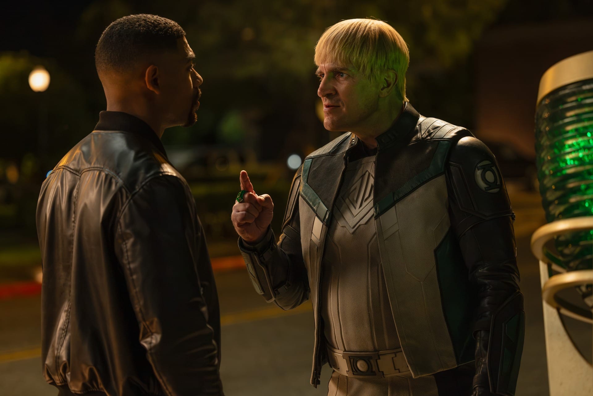 Production still featuring John and Guy at night, with Guy pointing a finger at John.