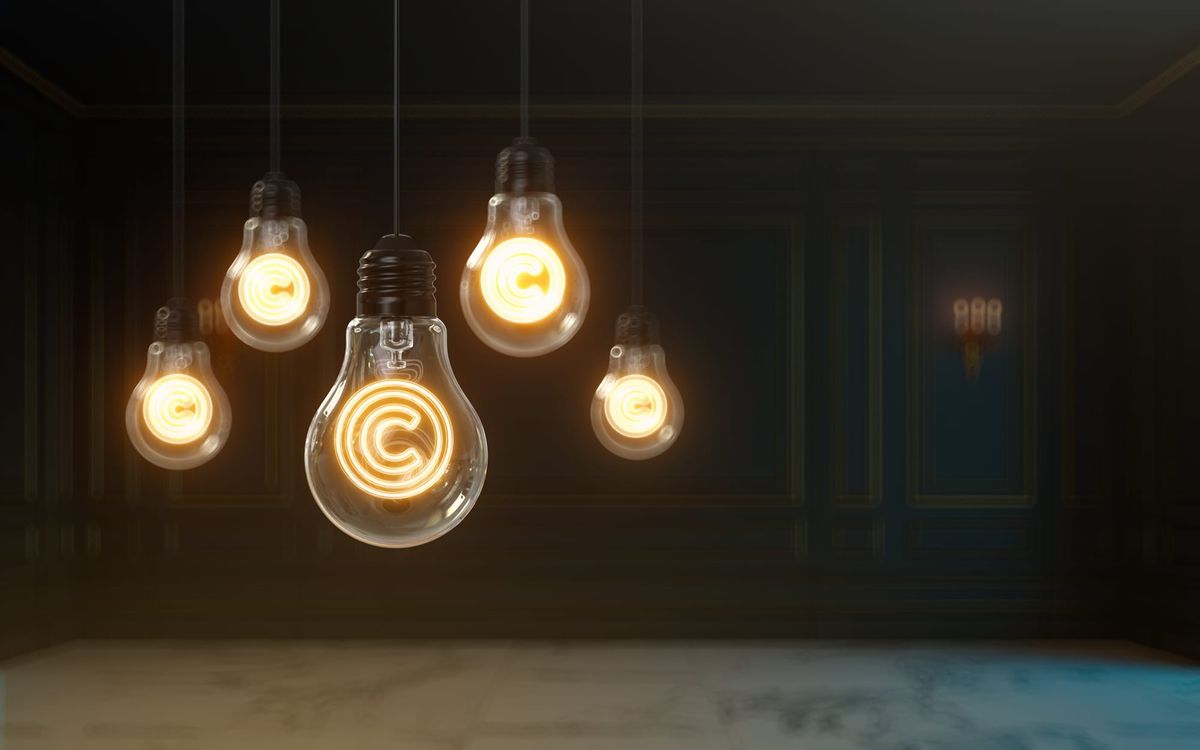 Image of five lightbulbs hanging upside-down with copyright symbols illuminated in them.