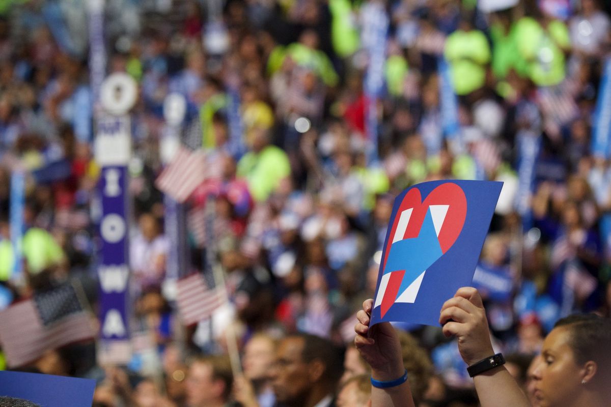 People at a rally hold up Hillary signs. Image credit: Gregory Reed/Shutterstock