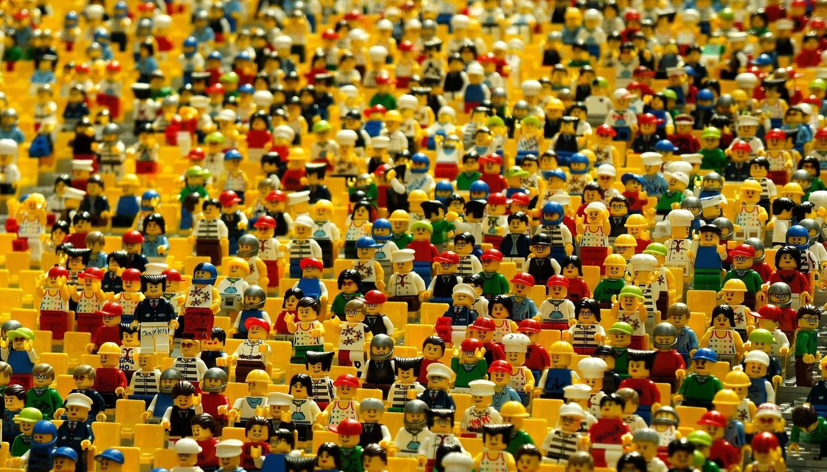 Image of many Legos in a yellow Lego stadium