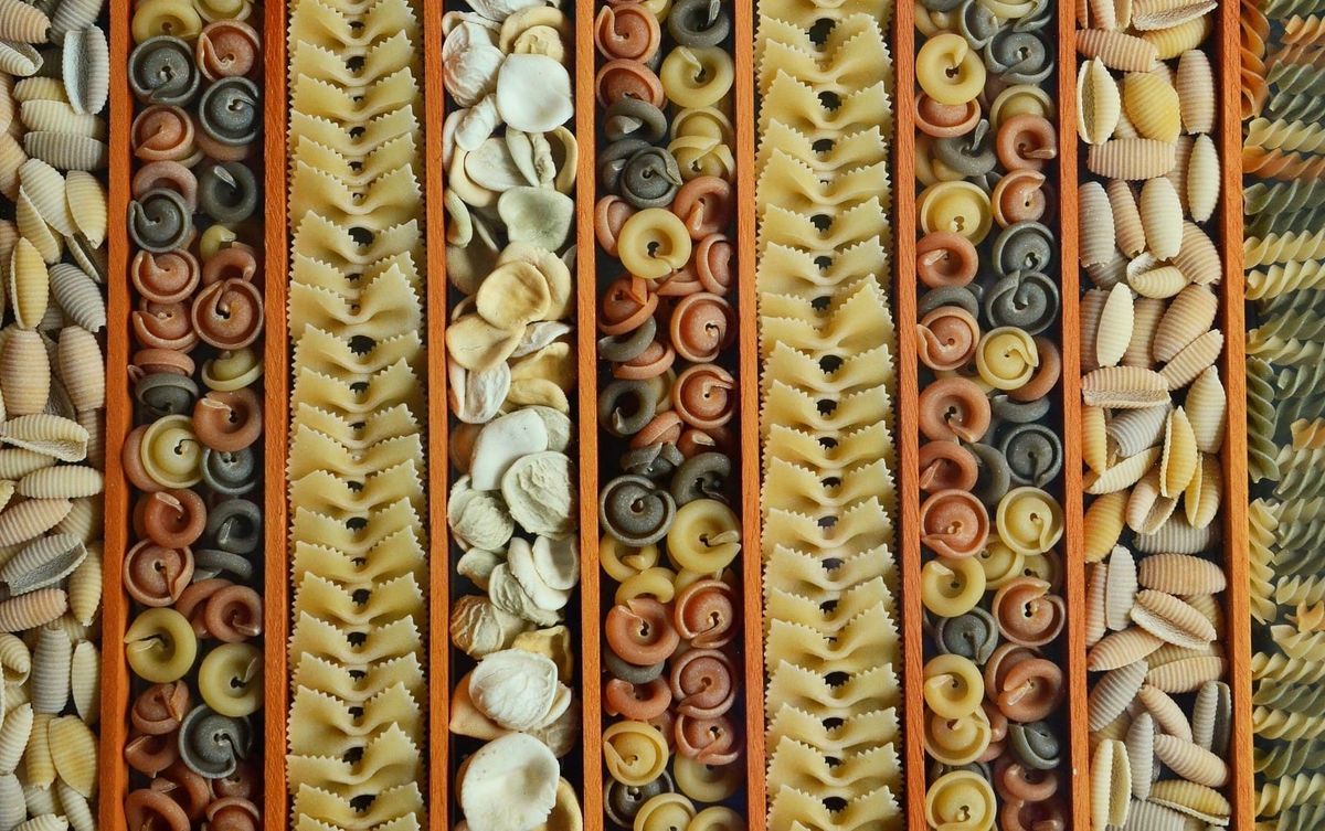 A photograph featuring rows of sorted pasta shapes