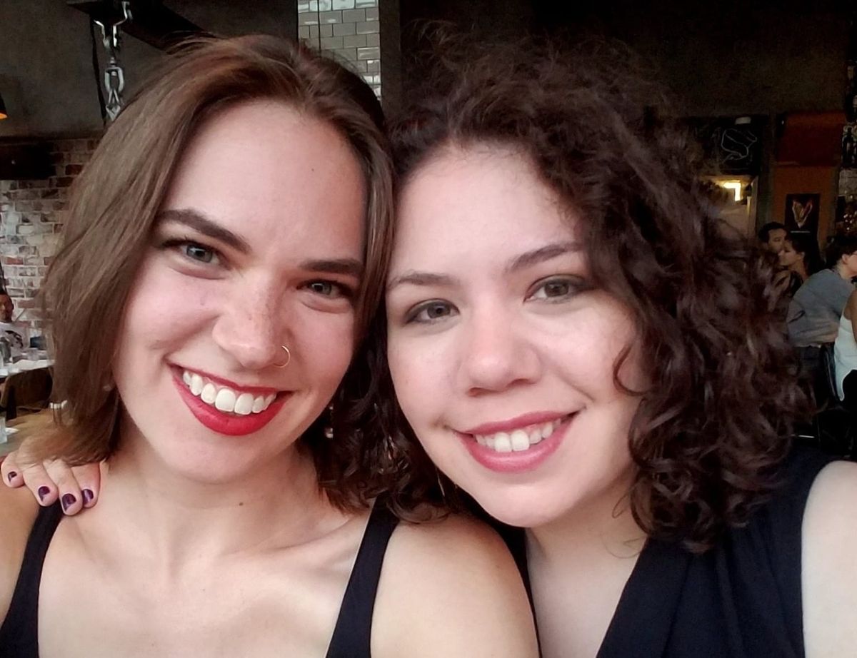 Flourish and Elizabeth, dressed for a party, smile at the camera. 