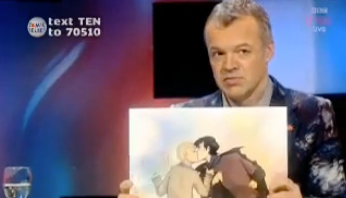 Graham Norton holding up a piece of Johnlock fanart. 
