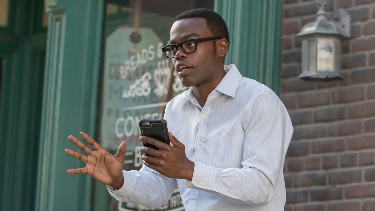 Image of Chidi holding his phone and looking anxious. 