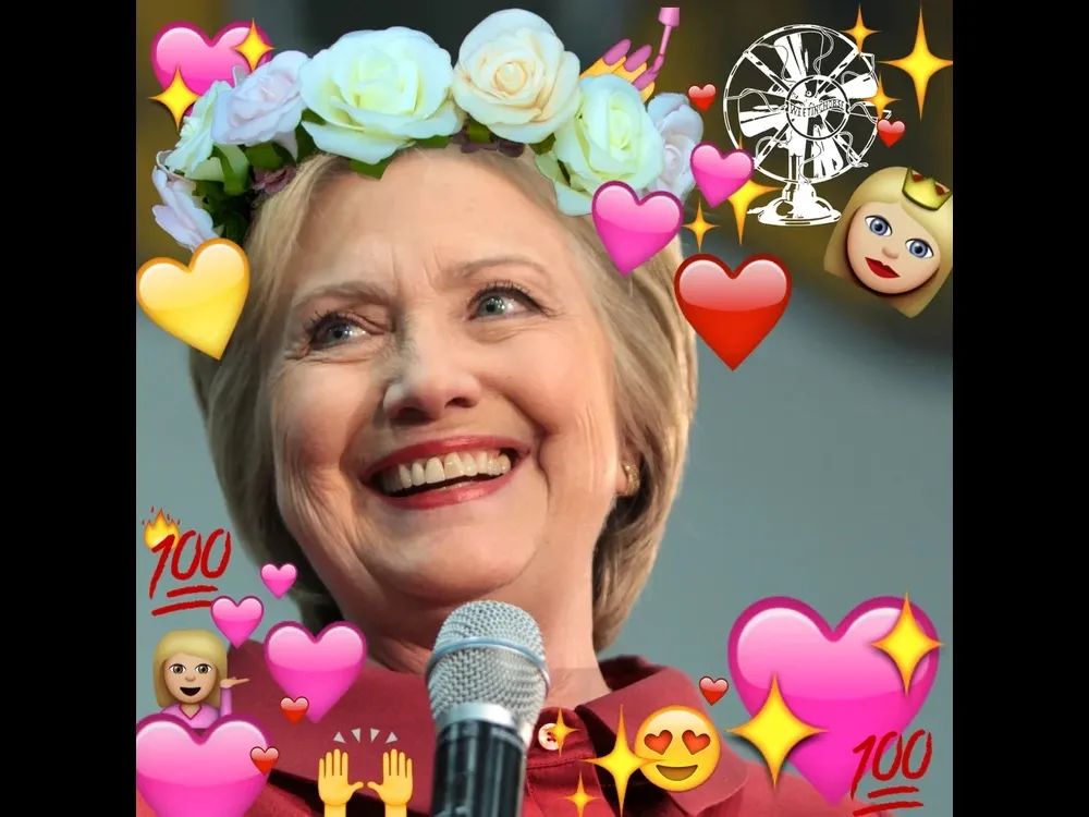 Hillary Clinton, photoshopped so that she is surrounded by positive emoji and wearing a flower crown. 