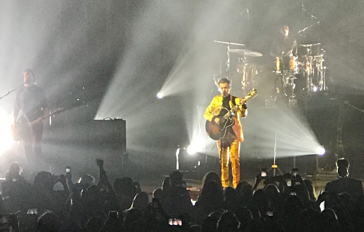 A grainy phone pic of a Harry Styles concert. 