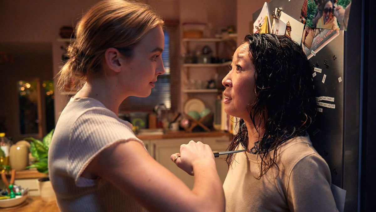 Still from Killing Eve featuring Villanelle holding a knife to Eve's throat. 