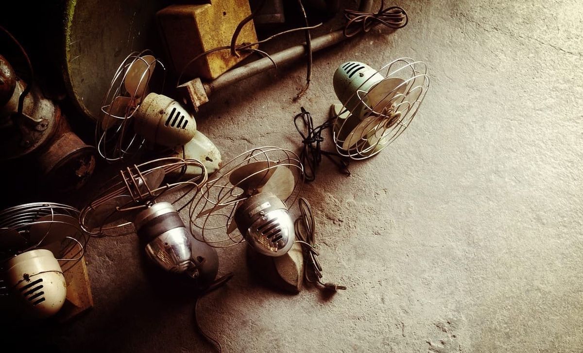 A collection of old electric fans.