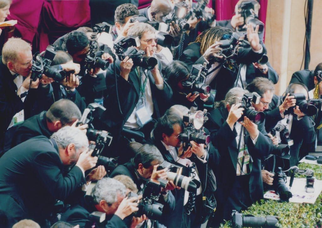 Photograph of a gaggle of paparazzi.