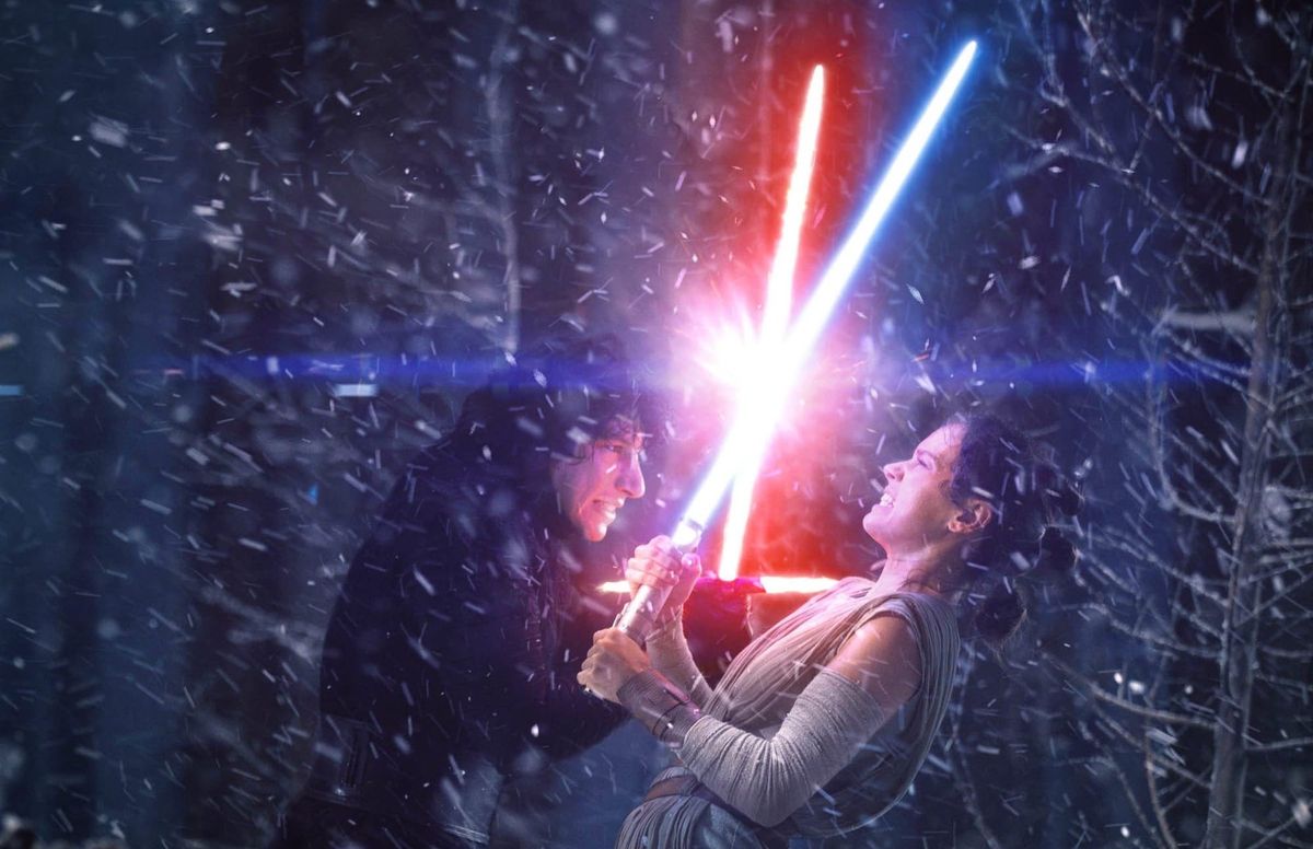 Kylo Ren and Rey fight with lightsabers. 