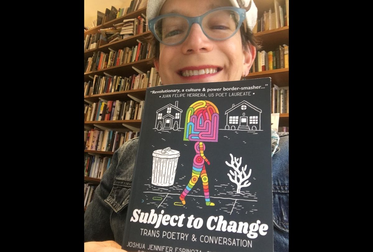 Stephanie Burt holding  Subject to Change, a book of trans poetry. 