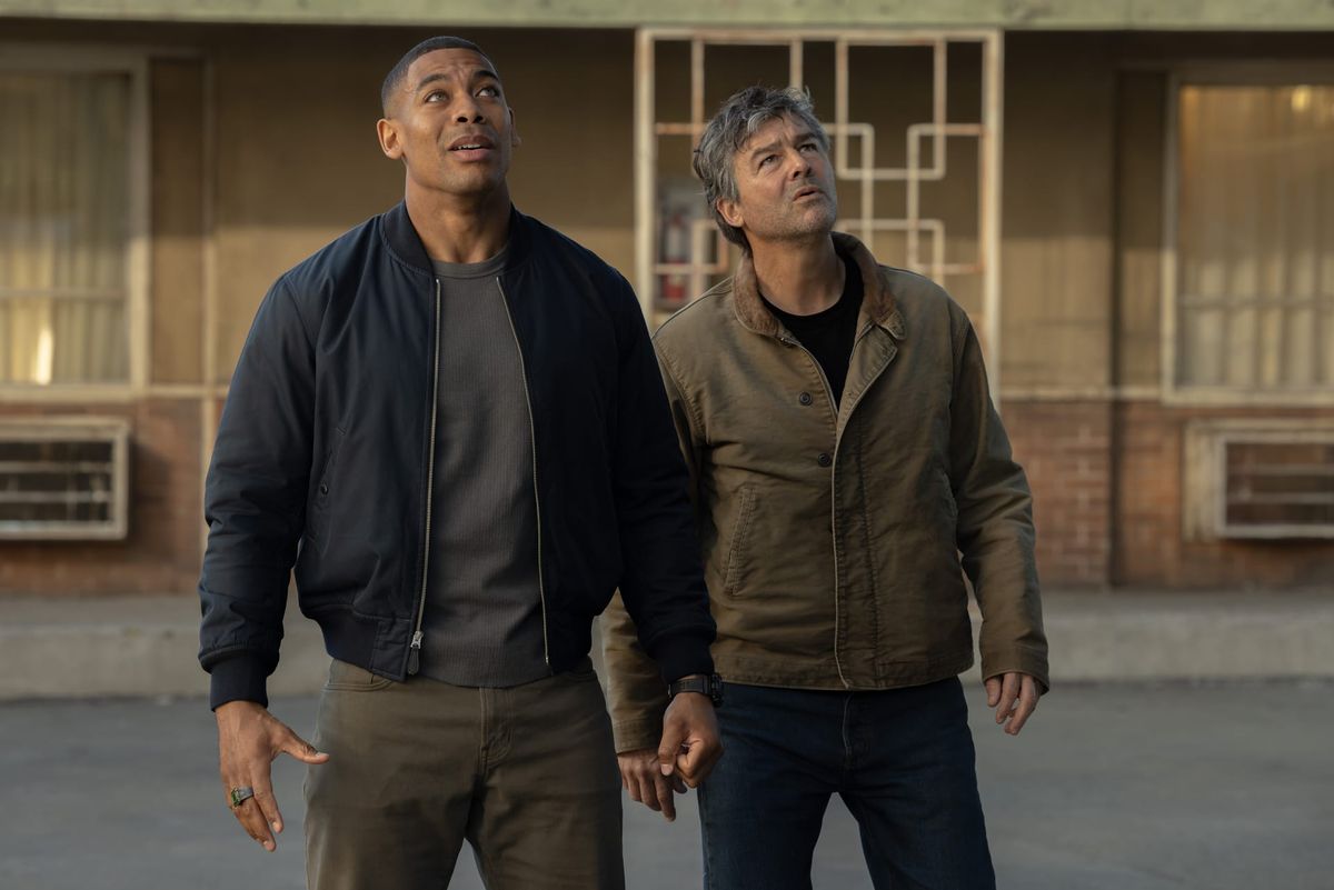 Production still featuring John and Hal looking upwards.