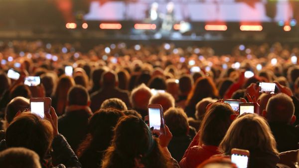 People with smart phones at a concert