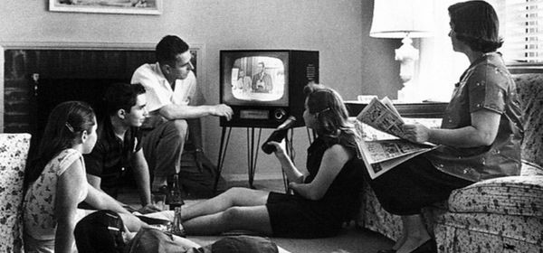  A 1950s family sits around and watches TV. 