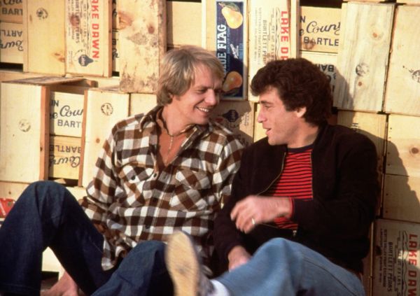 Photograph of Hutch and Starsky sitting together against a collection of stacked fruit crates.