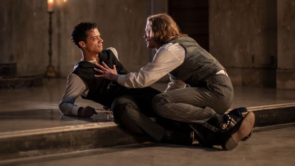 Photograph of Louis and Lestat crouched on the church altar, Lestat placing his hand across Louis's heart. 