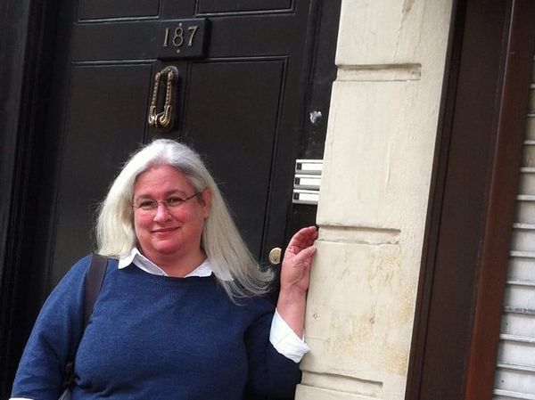 A photograph of Lori standing in front of the stand-in for the exterior of 221B Baker Street on Sherlock