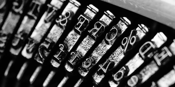 Black and white image of typewriter keys from the back.