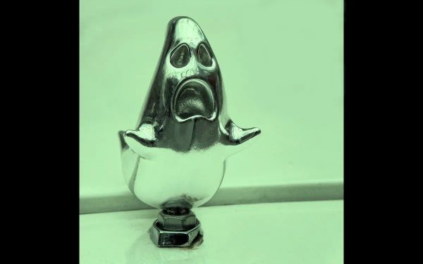 A ghost hood ornament, with a soft green filter.